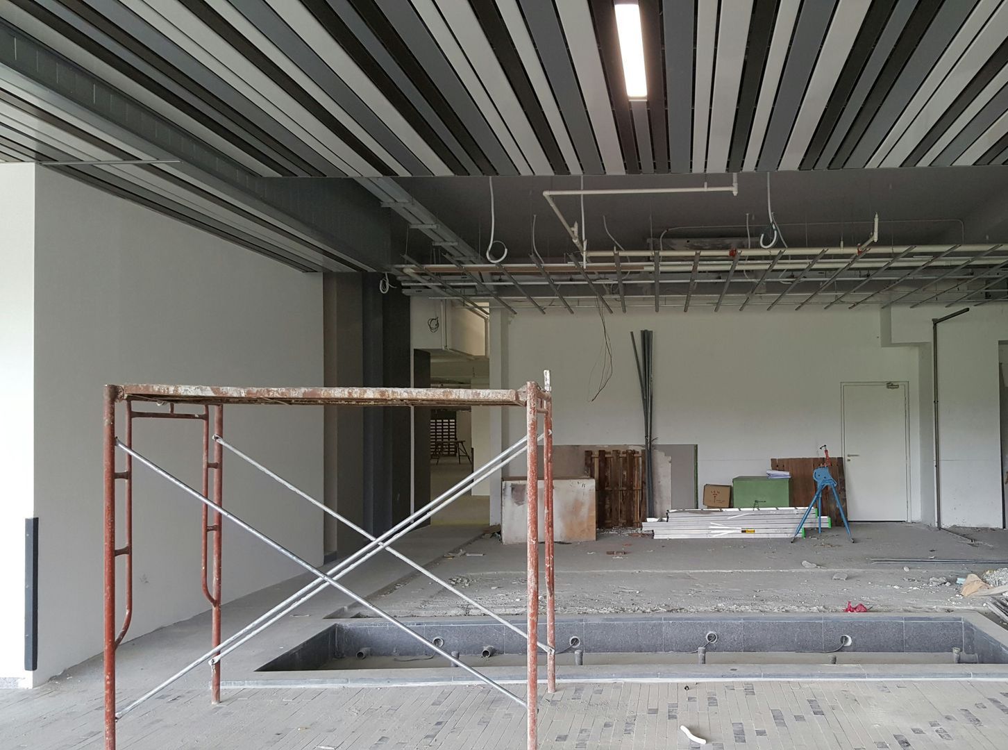 a man is standing in a large empty building